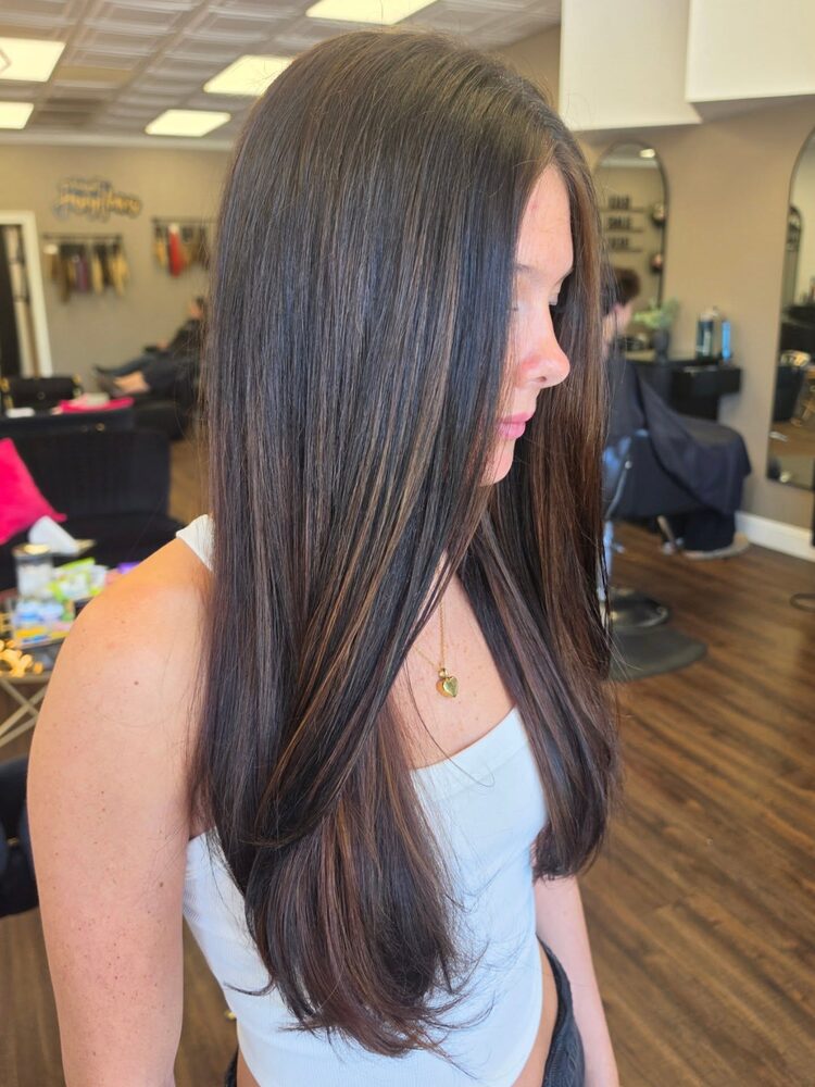Sleek brunette blowout, side profile